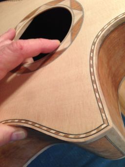 Detail of florentine cutaway and rope binding on aJay Rosenblatt Guitar